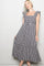 woman wearing a black and white gingham print midi dress with ruffled sleeves and a tiered hem