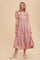 woman wearing a pink gingham tiered midi dress with ruffle sleeves and button details
