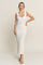 woman wearing a white ribbed knit sleeveless maxi dress with a scoop neckline and a fitted silhouette