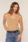 woman wearing a tan sleeveless top with a scoop neckline and high-waisted jeans