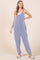 woman wearing a blue and white striped jumpsuit with wide legs and side pockets