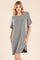 woman wearing a gray and black striped oversized t-shirt dress with short sleeves and side pockets