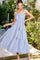 woman wearing a blue and white striped tiered maxi dress with smocked bodice and adjustable straps