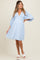 woman wearing a light blue striped maternity dress with a deep v-neck and puff sleeves