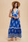 woman wearing a blue bohemian maxi dress with embroidered details and buttons, paired with a straw hat