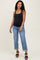 woman wearing a black maternity tank top and blue boyfriend jeans, showing her baby bump