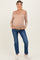 woman wearing a beige striped maternity sweater and blue jeans, displaying her baby bump