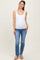 woman wearing a white maternity tank top and blue jeans, showing a visible baby bump