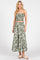 woman wearing a green and white floral print two-piece crop top and maxi skirt set