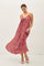 woman wearing a red patterned maxi dress with spaghetti straps and flowing skirt