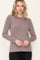 woman wearing a mauve long sleeve ribbed top with a crew neckline and a relaxed fit