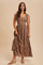 woman wearing a brown plaid midi dress with tie straps and a tiered skirt