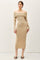 woman wearing a beige off-shoulder fitted midi dress with long sleeves and heeled mules