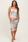 woman wearing a multi-colored maternity dress with ruching details, showcasing a baby bump