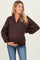 woman wearing a dark brown maternity pullover sweatshirt, showing her baby bump and styled with relaxed fit and quarter zip