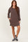 woman wearing a brown striped long sleeve dress with side pockets and a relaxed fit