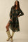 woman wearing a green floral long sleeve dress with a tiered skirt and tan knee-high boots