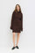 woman wearing a brown ribbed sweater dress with long sleeves and a fitted silhouette