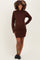woman wearing a brown ribbed long sleeve maternity dress, highlighting her baby bump