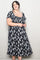 woman wearing a black floral plus size midi dress with puff sleeves and a square neckline