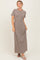 woman wearing a brown and white striped maxi dress with short sleeves and a relaxed fit