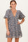 woman wearing a blue floral printed short dress with puff sleeves and a deep v-neckline