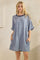 woman wearing a blue striped oversized t-shirt dress with rolled sleeves and side pockets