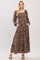 woman wearing a brown floral long sleeve maxi dress with a square neckline and pockets