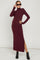 woman wearing a burgundy maternity maxi dress with a turtleneck and side slits, showcasing her baby bump