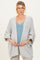 woman wearing a light gray maternity cardigan over a blue ribbed tank top and holding her baby bump