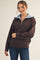 woman wearing a brown zip-up pullover sweater with a light blue collar and casual jeans