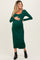 woman wearing a dark green long sleeve maternity dress, gently cradling her baby bump