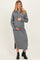 woman wearing a gray knitted maternity dress with buttons and holding her baby bump