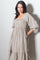 woman wearing a beige checkered puff sleeve maxi dress with smocked bodice and pockets