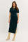 woman wearing a dark green polo style midi dress with short sleeves and side slits, paired with beige knee-high boots
