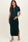 woman wearing a dark green maternity polo dress with side slits and a fitted silhouette, holding her baby bump