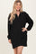 woman wearing a black long sleeve pullover dress with a half zip and side pockets