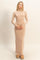 woman wearing a nude long sleeve form-fitting maxi dress with a high neckline and relaxed fit sleeves