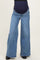 woman wearing a pair of light blue wide-leg maternity jeans with a dark blue over-the-bump panel