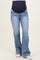 woman wearing light blue maternity flared jeans with a navy waistband