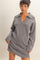 woman wearing a gray knit sweater dress with a collar and long sleeves