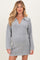 woman wearing a gray maternity dress with a collar and long sleeves, showcasing her baby bump