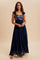 woman wearing a navy blue maxi dress with sequin details and ruffled straps