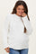 woman wearing a white cable knit maternity sweater and smiling, with her baby bump visible
