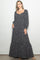 woman wearing a navy blue floral maxi dress with long sleeves and a square neckline, styled with a boho vibe