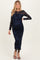 woman wearing a navy blue long sleeve maternity dress with floral lace detail and a visible baby bump