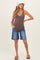 woman wearing a brown ribbed maternity tank top and denim bermuda shorts, showing her baby bump