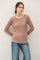 woman wearing a taupe long sleeve ribbed top paired with blue jeans