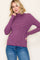woman wearing a purple and white striped long sleeve turtleneck sweater with fitted sleeves and a relaxed fit