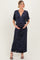 woman wearing a navy floral print maternity maxi dress, holding her baby bump with a v-neck and flutter sleeves